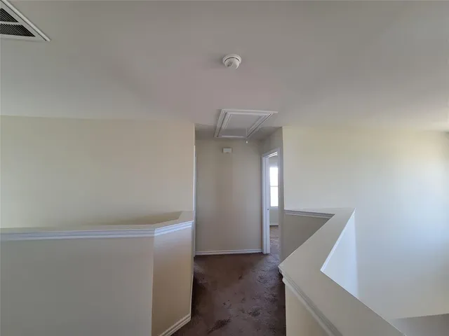 a view of a hallway with staircase