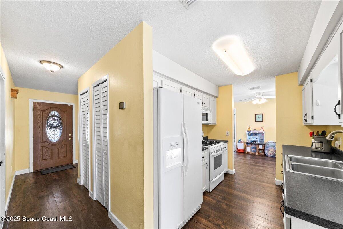 985 Sycamore Drive Rockledge, FL 32955 - Photo 11 of 26 a view of a hallway view with wooden floor and furniture