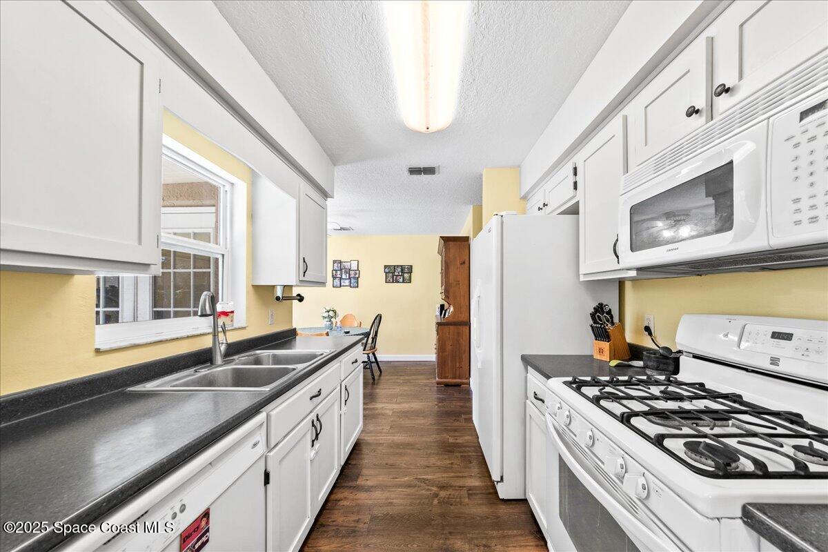 985 Sycamore Drive Rockledge, FL 32955 - Photo 13 of 26 a kitchen with stainless steel appliances a sink a stove and a window