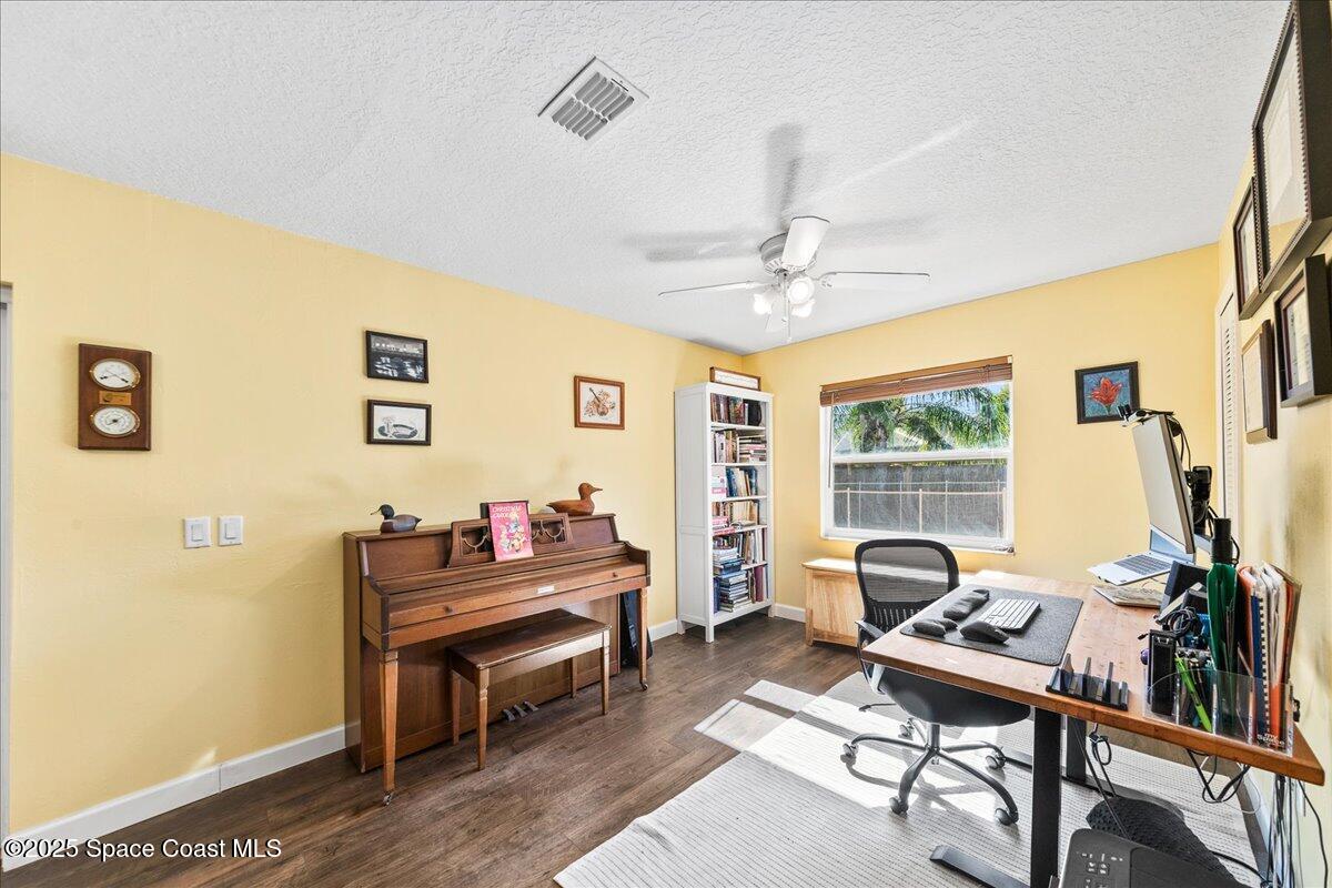 985 Sycamore Drive Rockledge, FL 32955 - Photo 14 of 26 a living room with furniture a piano and a window