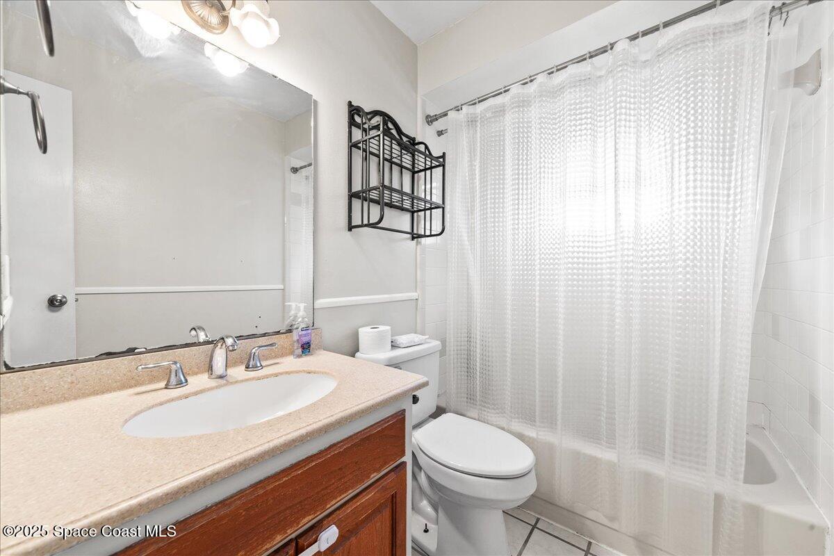 985 Sycamore Drive Rockledge, FL 32955 - Photo 20 of 26 a bathroom with a sink toilet and shower
