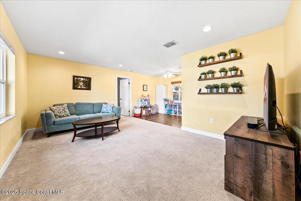 985 Sycamore Drive Rockledge, FL 32955 - Photo 4 of 26 a living room with furniture and a flat screen tv