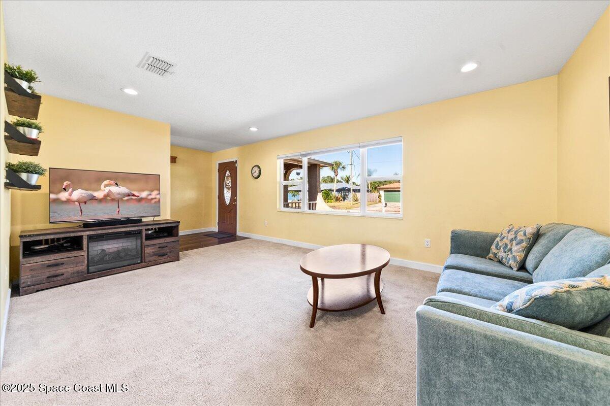 985 Sycamore Drive Rockledge, FL 32955 - Photo 5 of 26 a living room with furniture and a flat screen tv