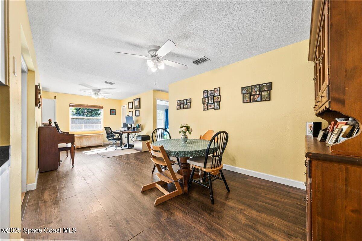 985 Sycamore Drive Rockledge, FL 32955 - Photo 8 of 26 a view of a dining room with furniture and wooden floor