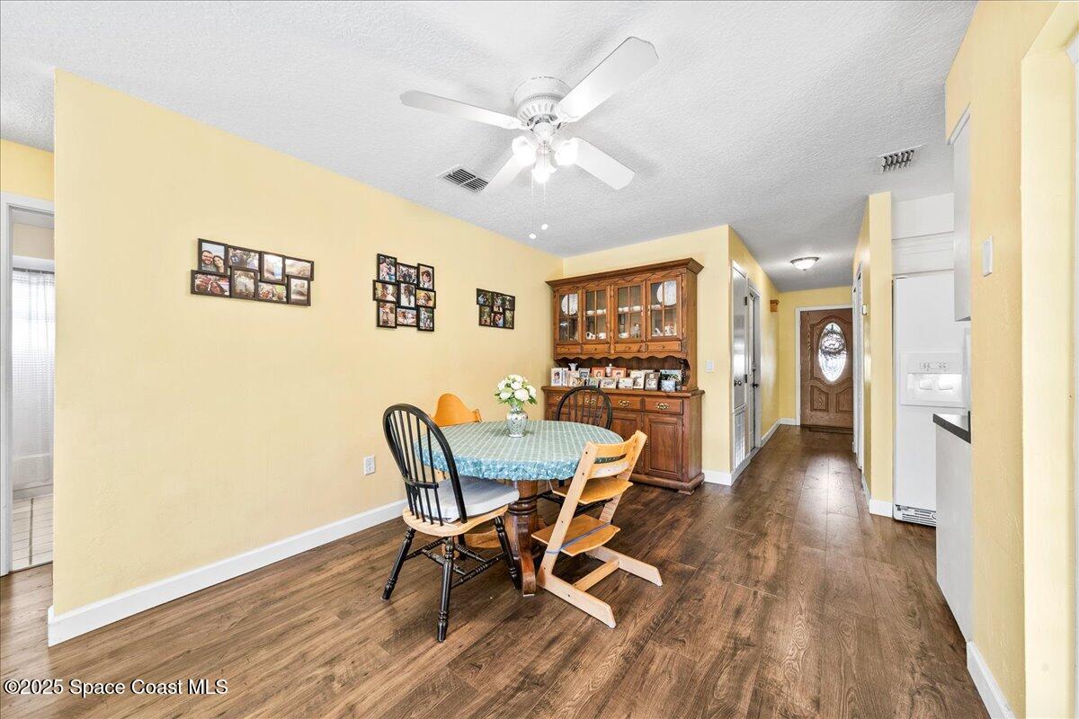 985 Sycamore Drive Rockledge, FL 32955 - Photo 10 of 26 a view of a dining room with furniture and wooden floor