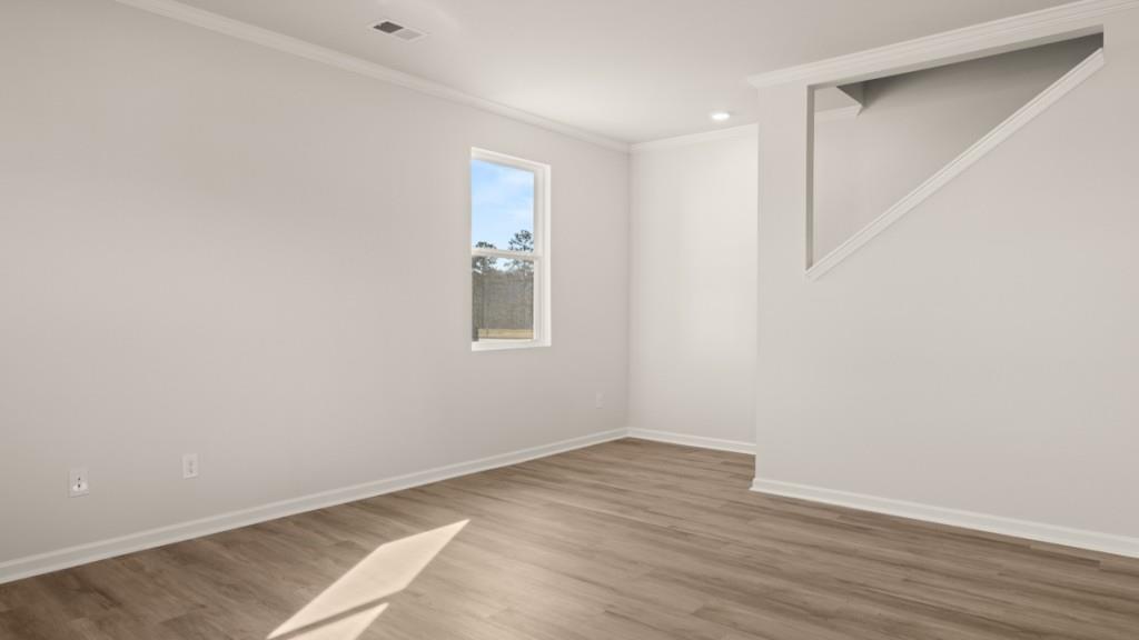 703 Anchor Avenue Villa Rica, GA 30180 - Photo 15 of 32 an empty room with wooden floor and windows