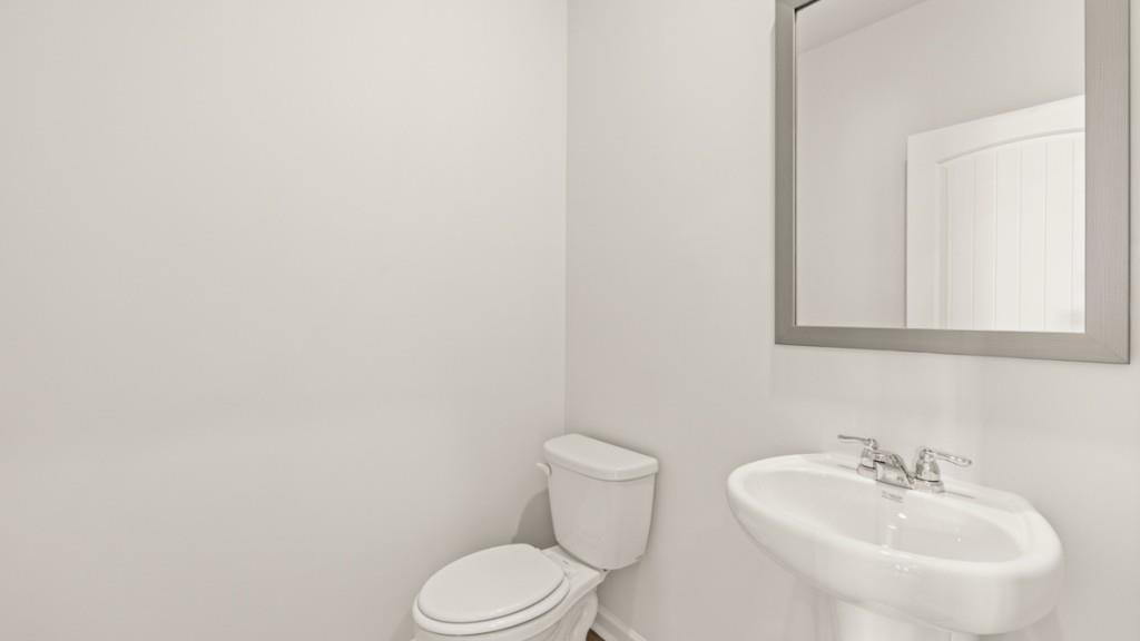 703 Anchor Avenue Villa Rica, GA 30180 - Photo 16 of 32 a bathroom with a sink a toilet and mirror