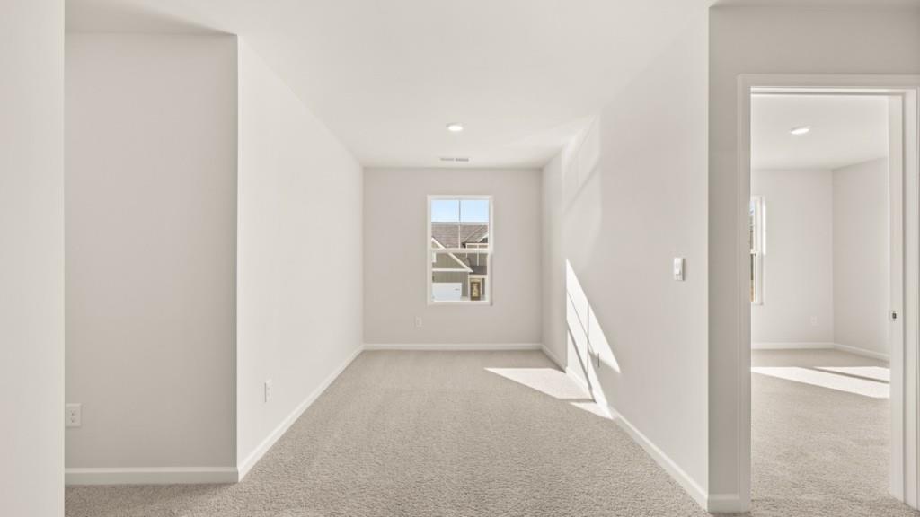 703 Anchor Avenue Villa Rica, GA 30180 - Photo 18 of 32 a view of a hallway with white walls and stairs