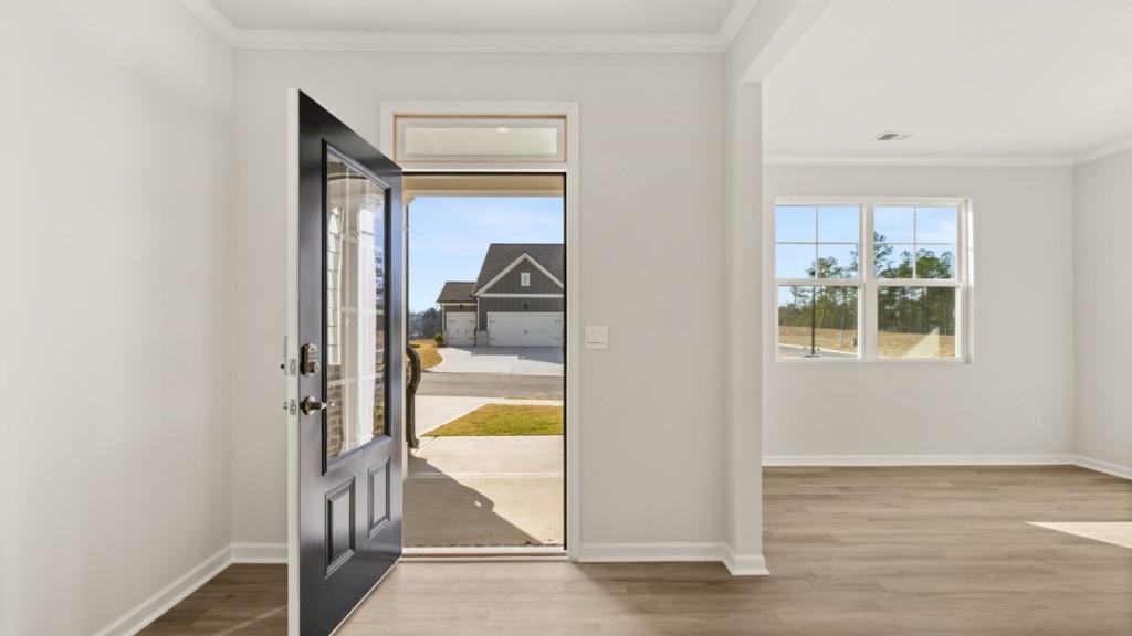 703 Anchor Avenue Villa Rica, GA 30180 - Photo 5 of 32 a view of a bedroom with wooden floor and a bed