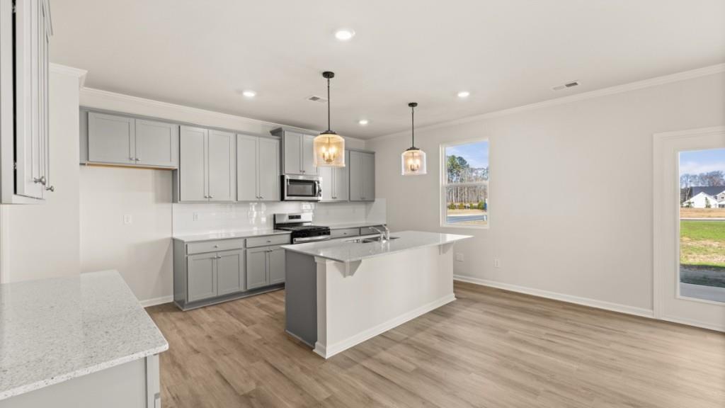 703 Anchor Avenue Villa Rica, GA 30180 - Photo 8 of 32 a kitchen with a stove a sink and a refrigerator