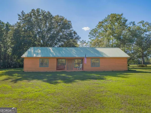 a view of a house with a yard and a garage