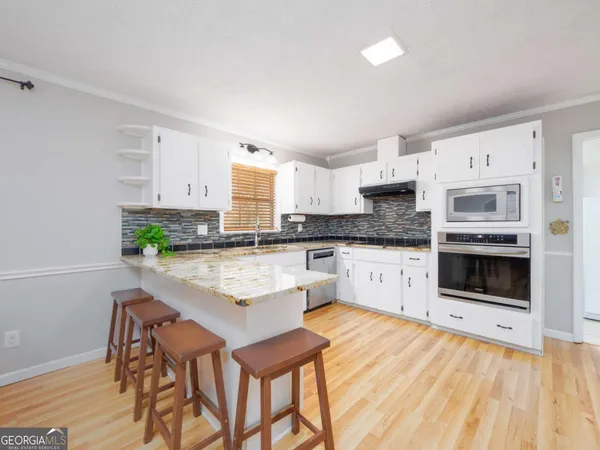 a kitchen with a refrigerator sink and cabinets