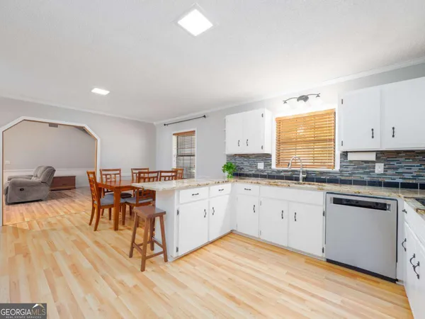 a kitchen with stainless steel appliances granite countertop a stove a microwave and cabinets