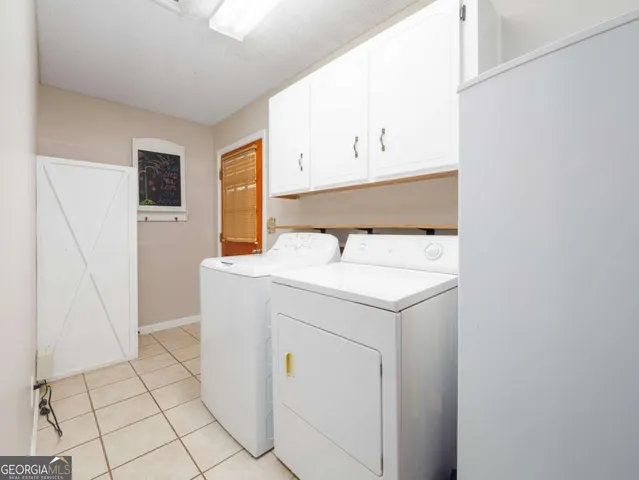 a living room with furniture and floor to ceiling windows