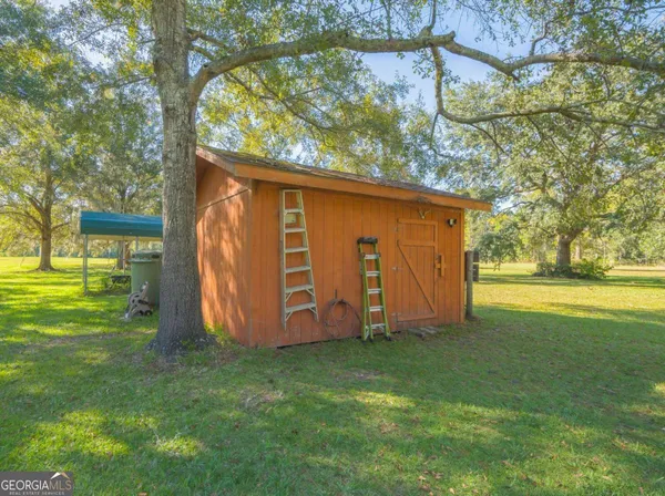 a view of yard with swimming pool and green space
