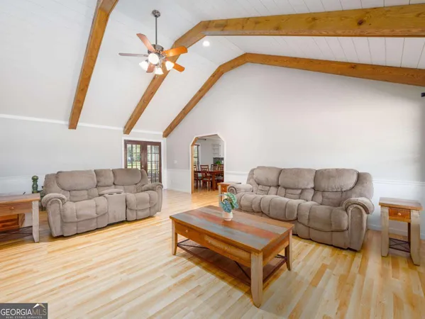 a living room with furniture and a chandelier