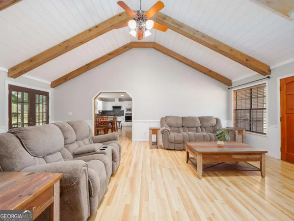 a dining room with furniture and wooden floor