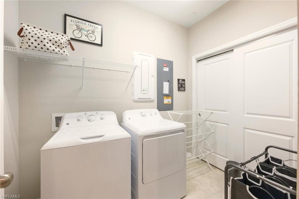 9365 Pocida Court, Unit 202 Naples, FL 34119 - Photo 26 of 40 a utility room with dryer and washer