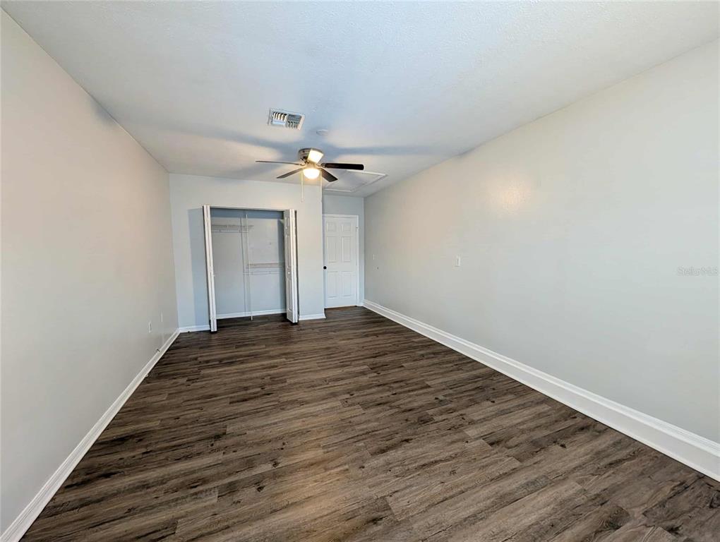 1511 Southwest Shorewood Drive Dunnellon, FL 34431 - Photo 16 of 31 a view of a room with wooden floor and chandelier fan