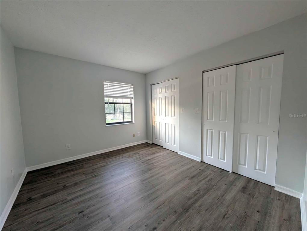 1511 Southwest Shorewood Drive Dunnellon, FL 34431 - Photo 21 of 31 a view of an empty room with wooden floor and a window
