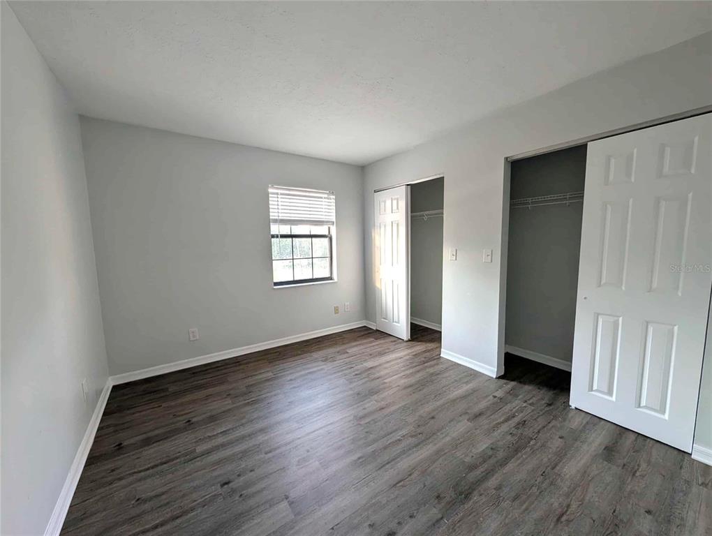 1511 Southwest Shorewood Drive Dunnellon, FL 34431 - Photo 22 of 31 an empty room with wooden floor and windows