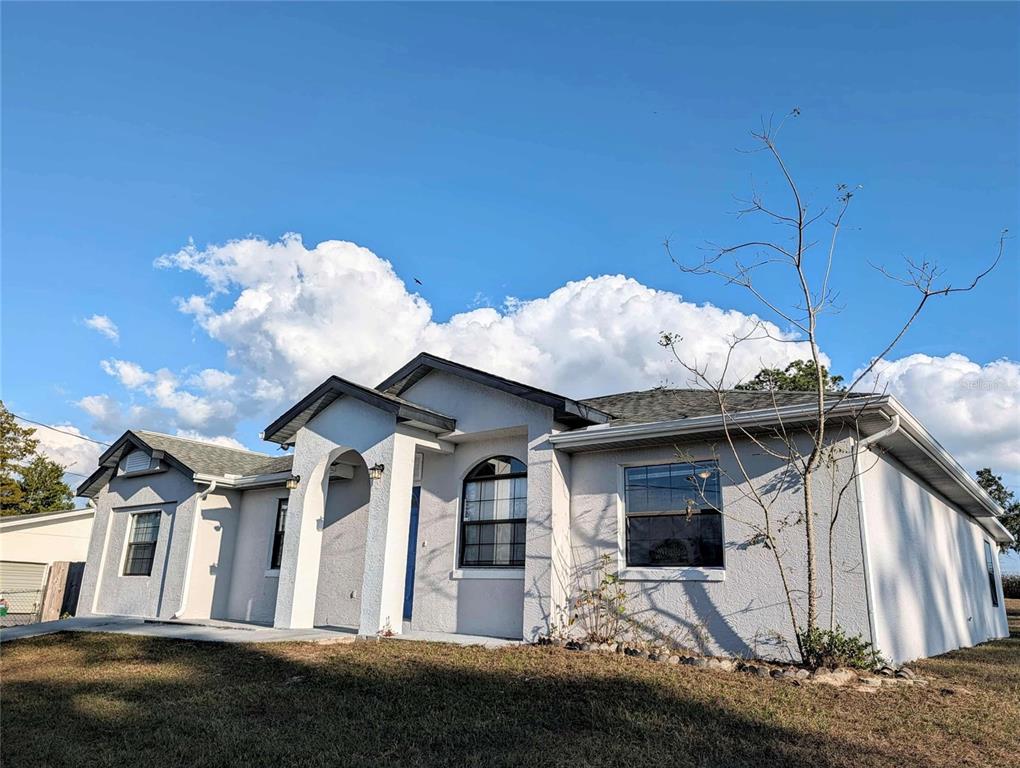 1511 Southwest Shorewood Drive Dunnellon, FL 34431 - Photo 30 of 31 a view of a white house with a sink and backyard