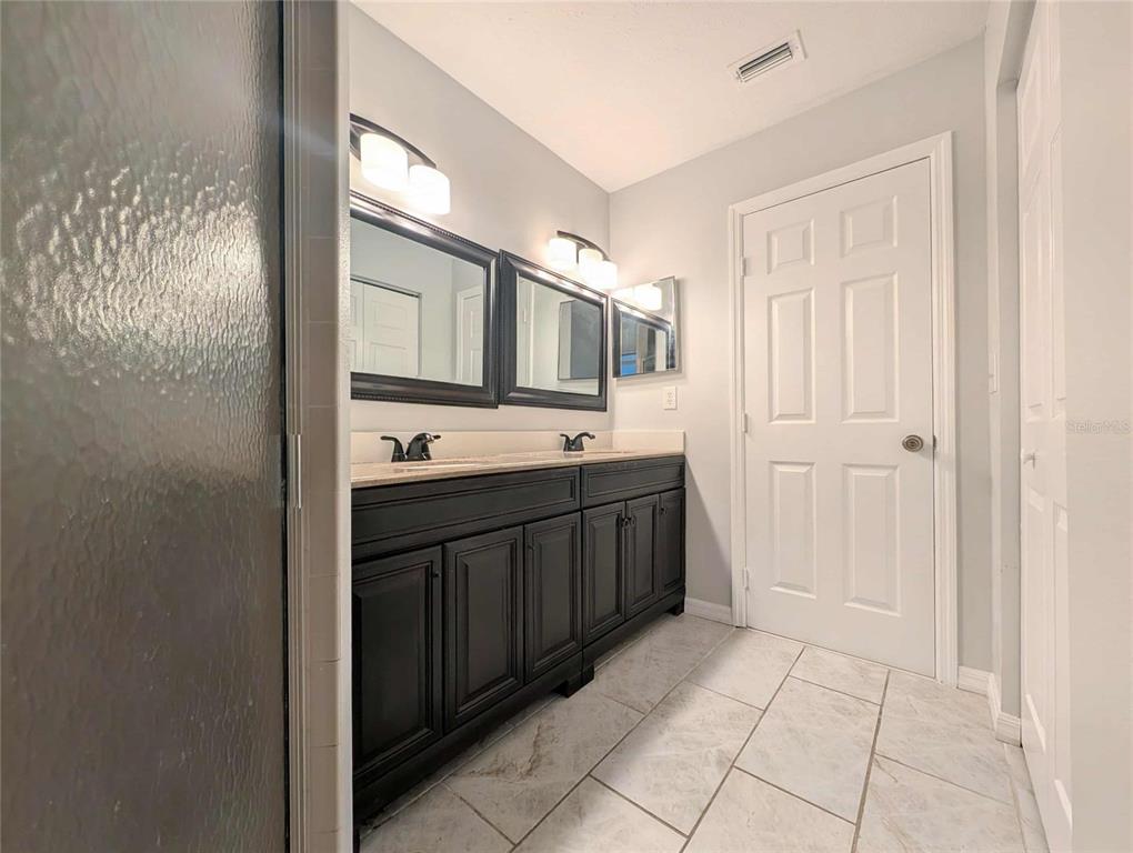 1511 Southwest Shorewood Drive Dunnellon, FL 34431 - Photo 7 of 31 a spacious bathroom with a mirror a sink and a shower