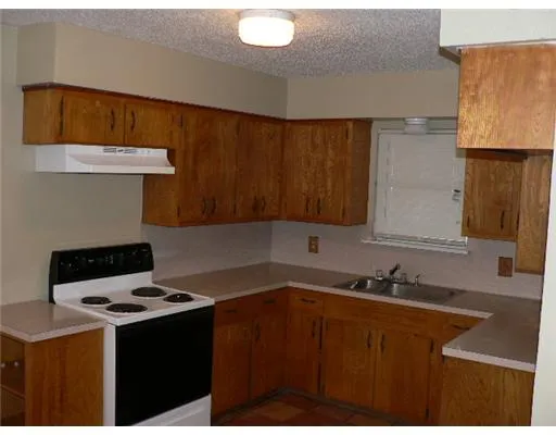a kitchen with a sink a stove and a cabinets