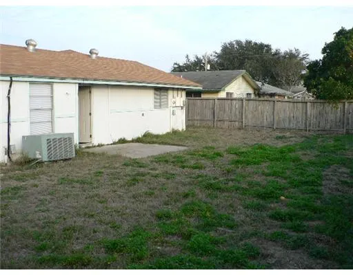 a view of house with backyard and garden