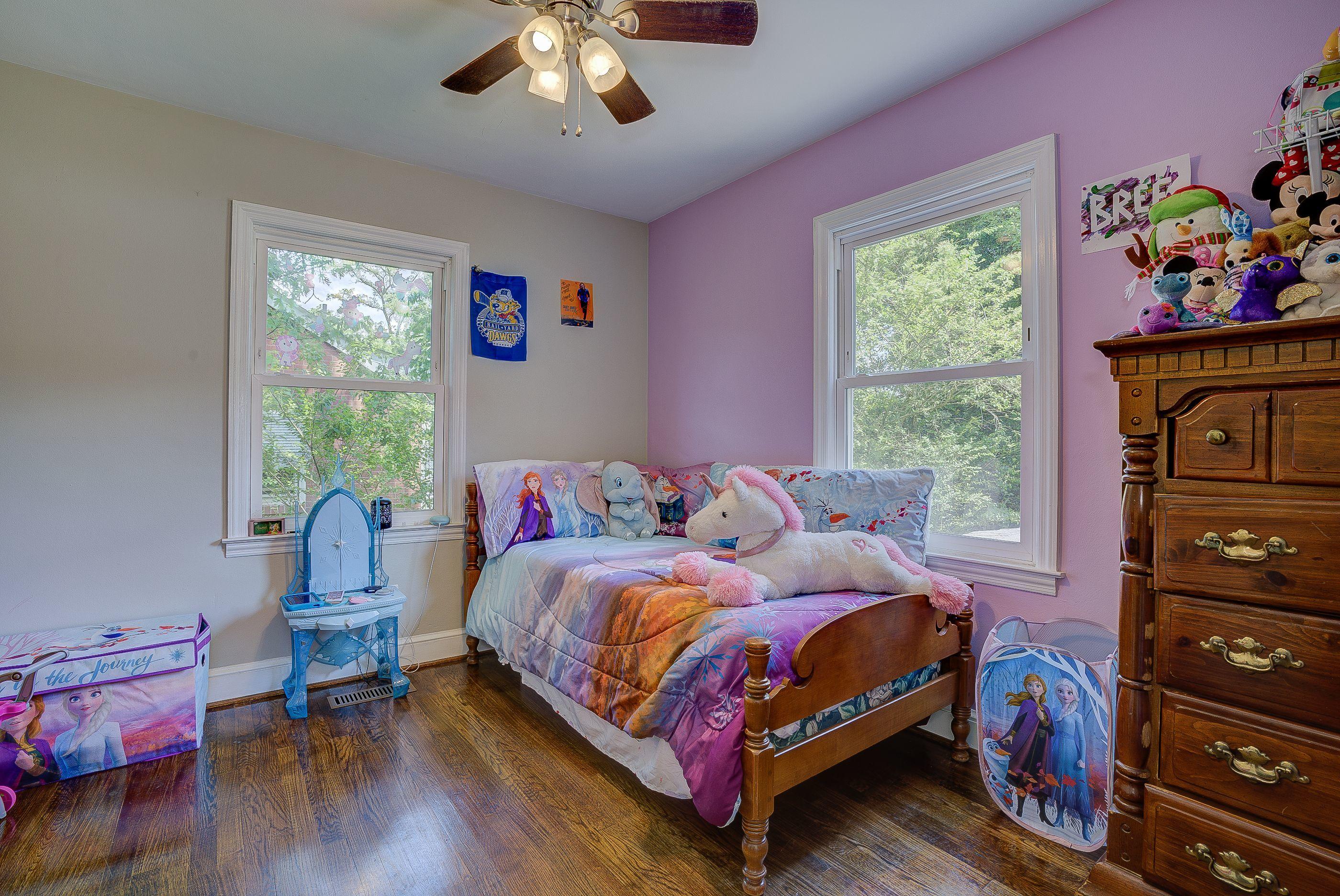 4417 Goodman Road Roanoke, VA 24014 - Photo 8 of 13 a bedroom with a bed and wooden floor