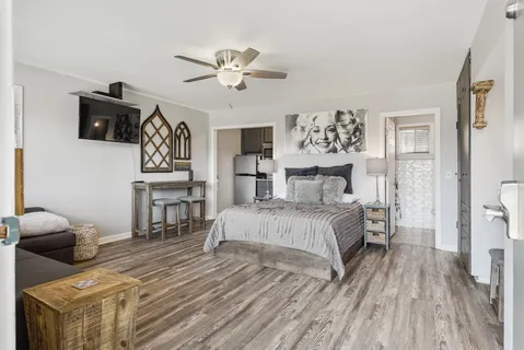 a bedroom with a bed and a tv on table