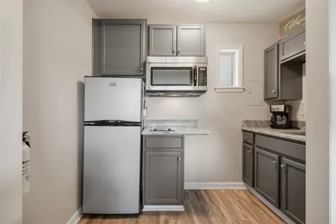 a kitchen with a refrigerator stove and microwave