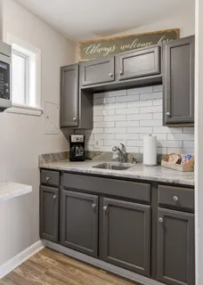 a kitchen with granite countertop cabinets and sink