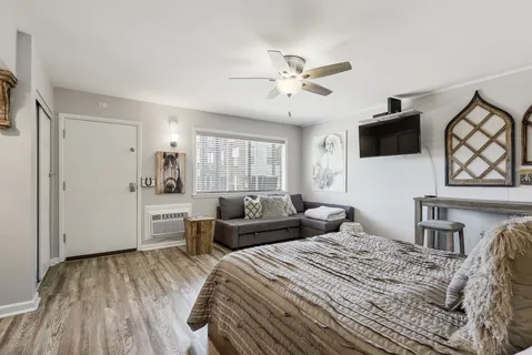 a bedroom with a large bed and a tv
