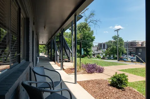 a view of a chair and tables in the patio