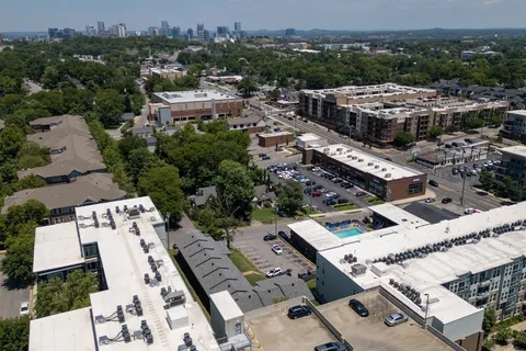 an aerial view of a house with a city view