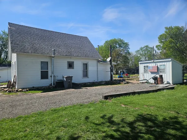 a view of a house with backyard and sitting area