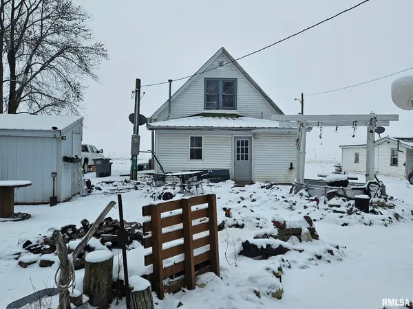 a view of kitchen with a table and chairs in it