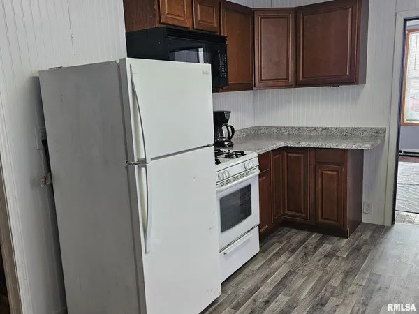 a white refrigerator freezer and a stove sitting inside of a kitchen