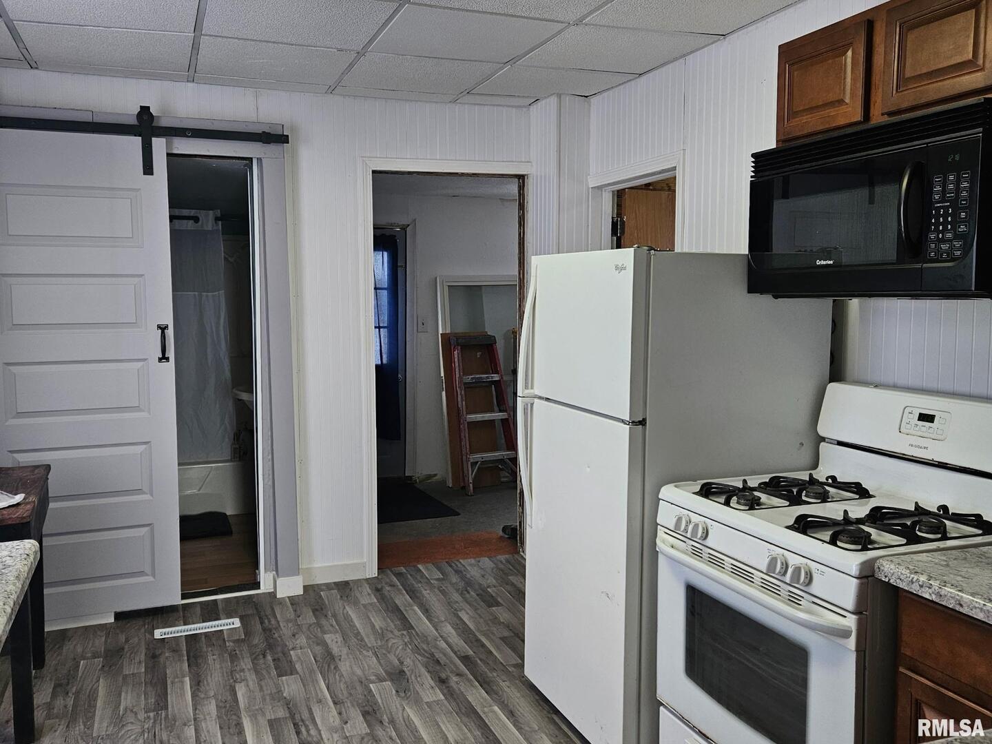201 East May Street Joy, IL 61260 - Photo 5 of 18 a kitchen with a stove a refrigerator and a microwave