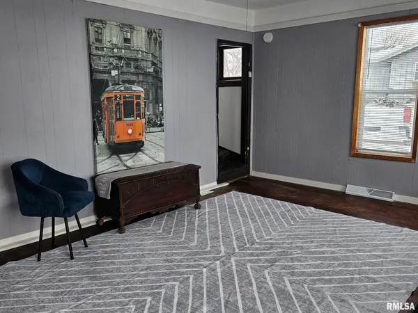 a bedroom with furniture and a window