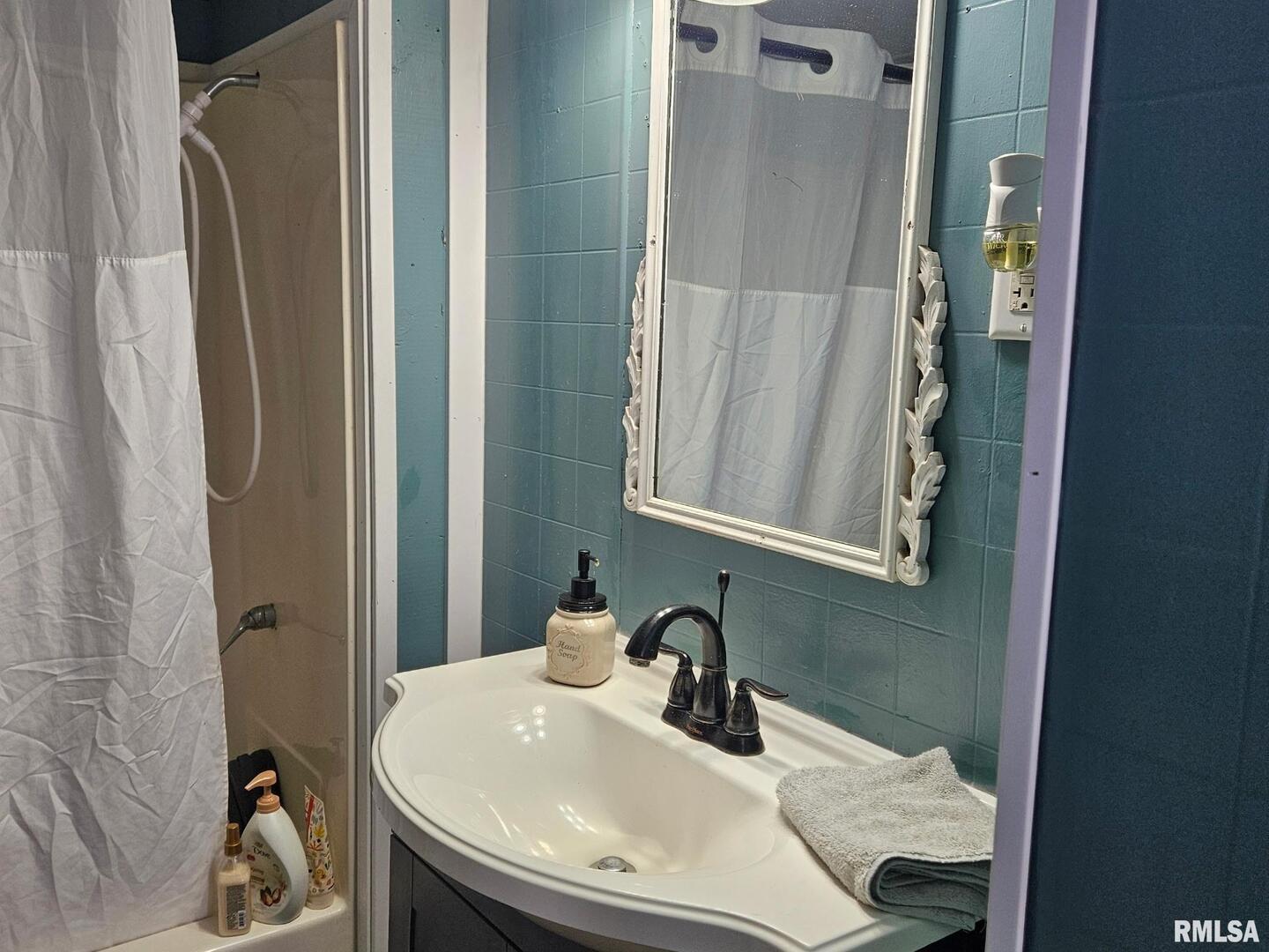 201 East May Street Joy, IL 61260 - Photo 10 of 18 a bathroom with a sink and a mirror