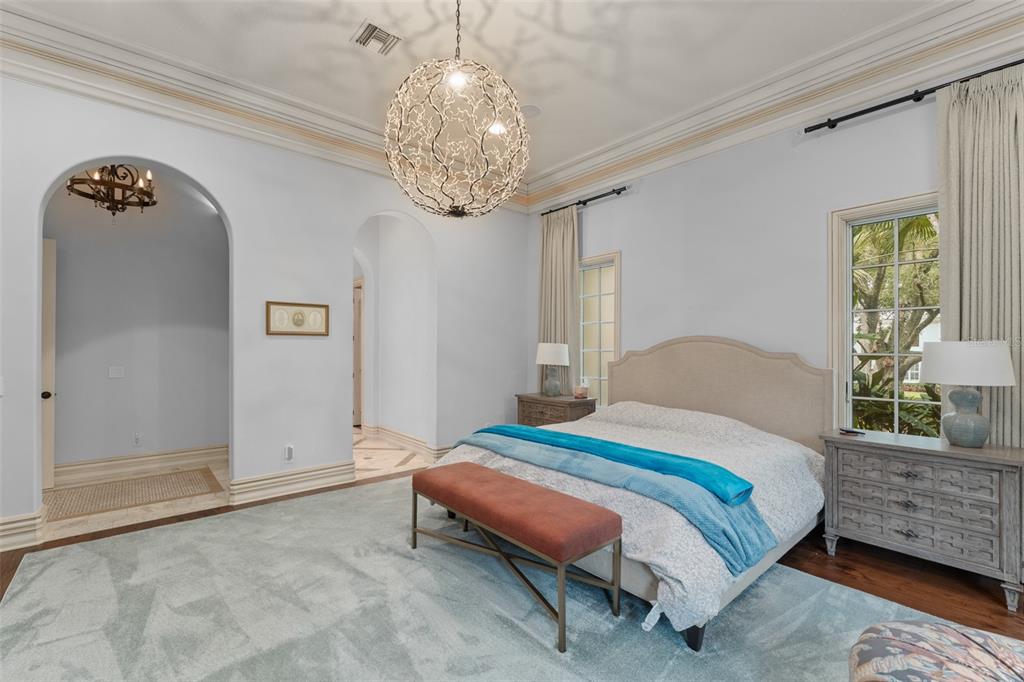 4812 Alexandra Garden Court Windermere, FL 34786 - Photo 19 of 65 a bedroom with a bed and a chandelier