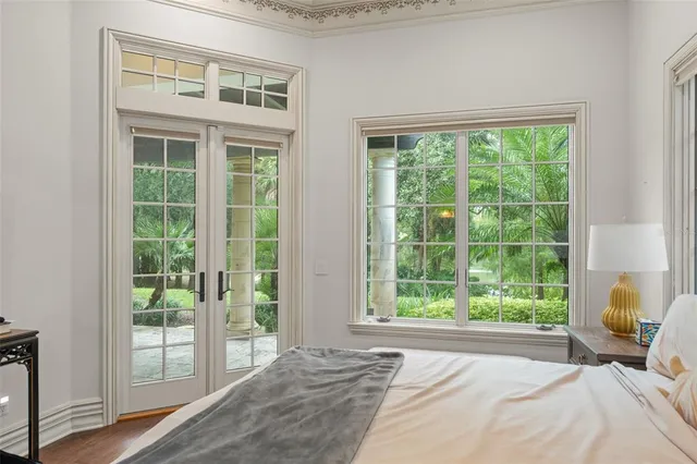 a living room with furniture a fireplace and a chandelier