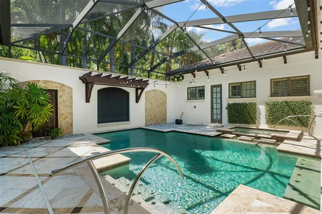a view of a house with backyard and sitting area