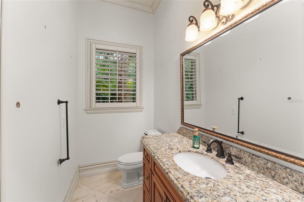 4812 Alexandra Garden Court Windermere, FL 34786 - Photo 31 of 65 a bathroom with a granite countertop sink a mirror and a toilet