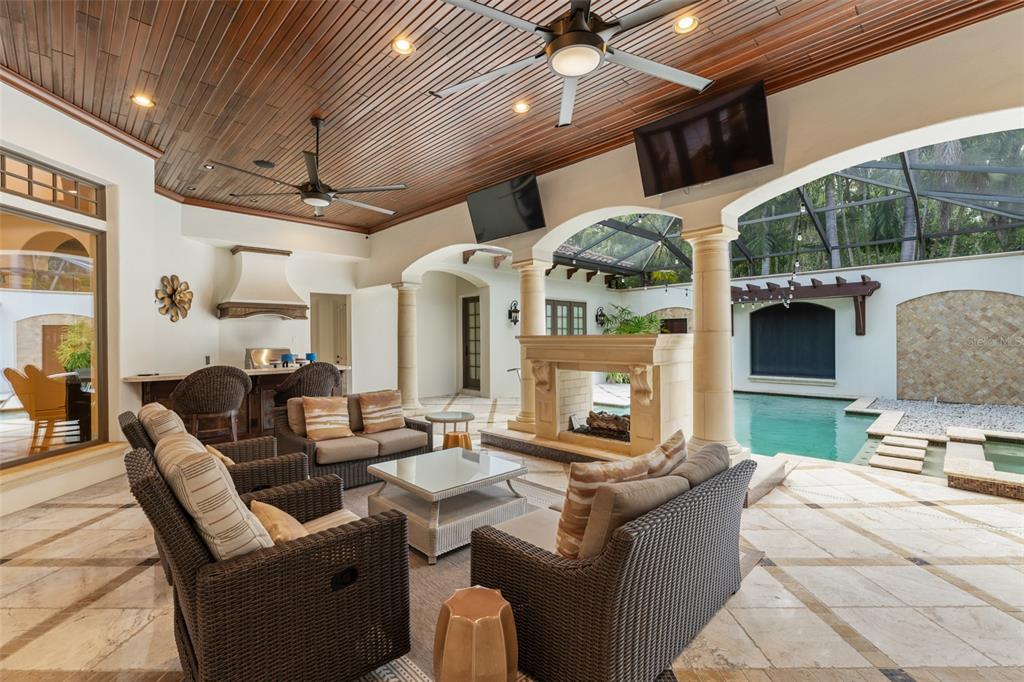 4812 Alexandra Garden Court Windermere, FL 34786 - Photo 33 of 65 a living room with furniture a fireplace and a dining table with wooden floor