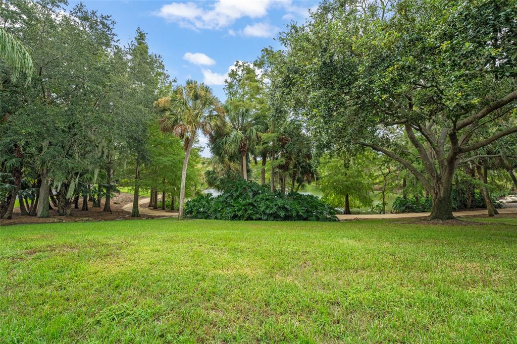 4812 Alexandra Garden Court Windermere, FL 34786 - Photo 56 of 65 a view of a field of grass and trees
