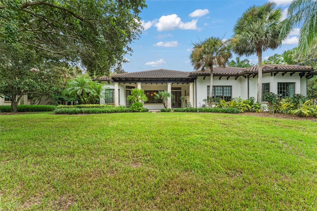 4812 Alexandra Garden Court Windermere, FL 34786 - Photo 59 of 65 a front view of a house with a garden