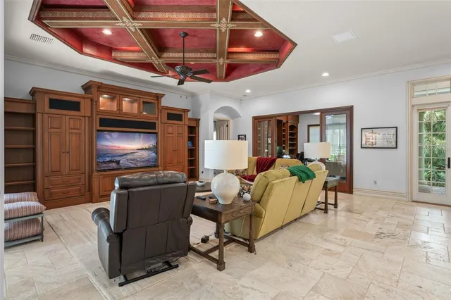 a living room with furniture and a ceiling fan